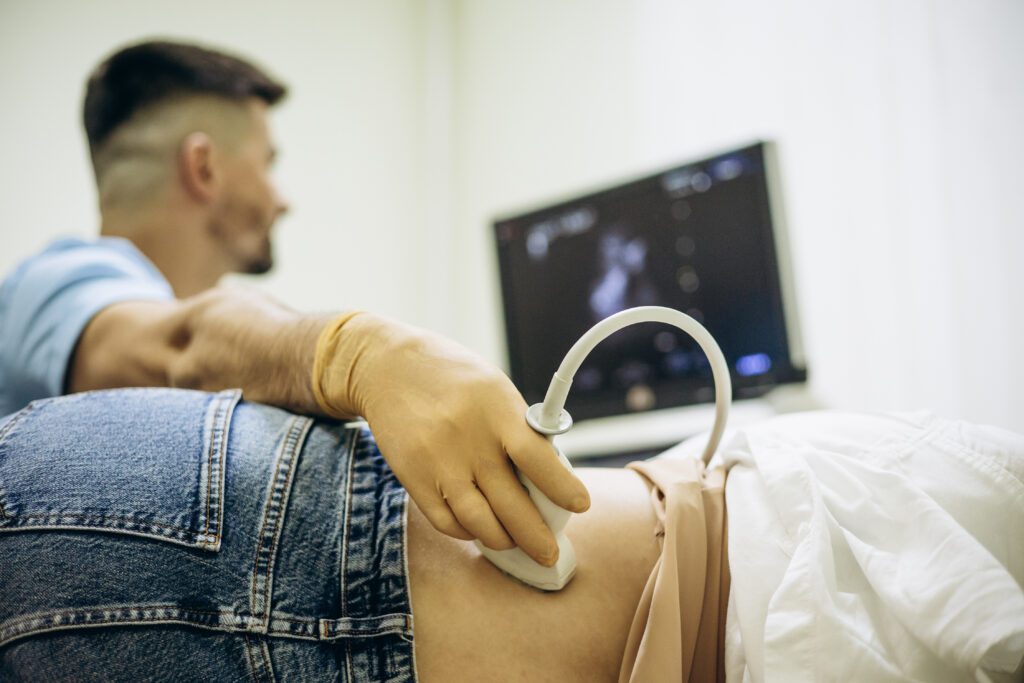 Technologist with patient doing ultrasound check-up