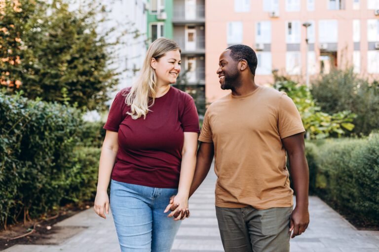 Portrait of smiling couple holding hands walking